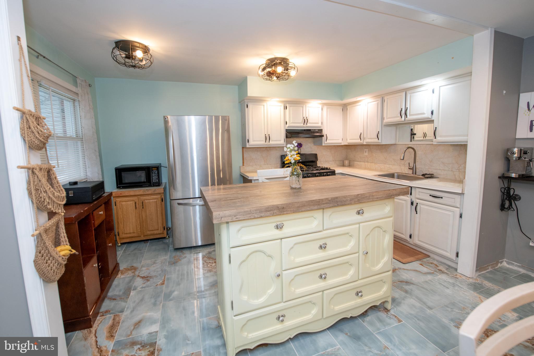 12506 Chilton Road Philadelphia, PA 19154 - Photo 22 of 55 a kitchen with cabinets stainless steel appliances a sink and a refrigerator