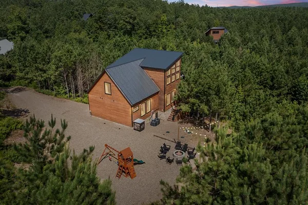an aerial view of a house with a yard