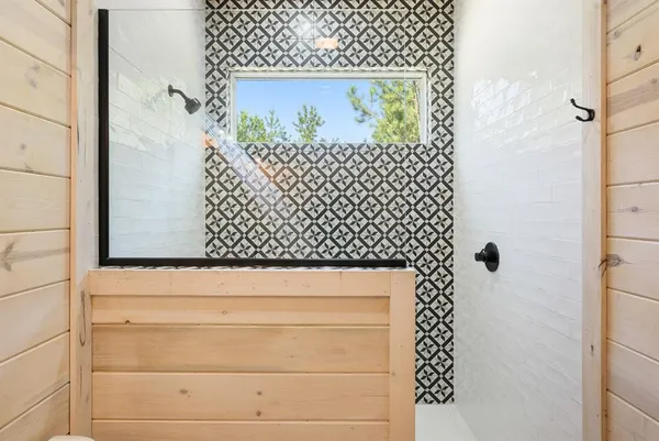 a bathroom with a shower and a sink