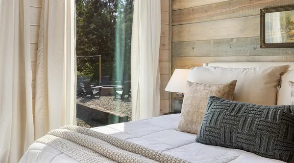 a bedroom with a bed and balcony view