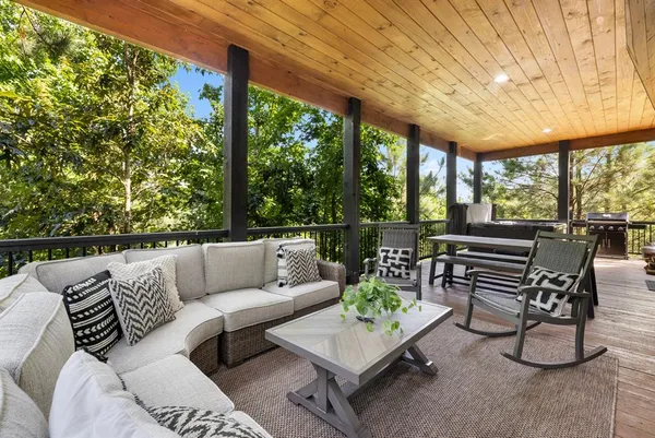 a roof deck with couches and potted plants