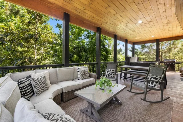 a view of a bedroom with wooden floor and furniture