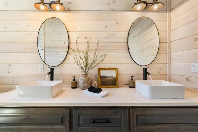 a living room with furniture a fireplace and a floor to ceiling window