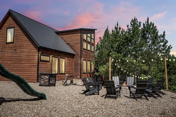 a backyard of a house with table and chairs