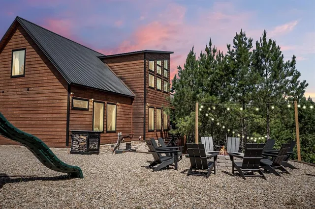 a backyard of a house with table and chairs