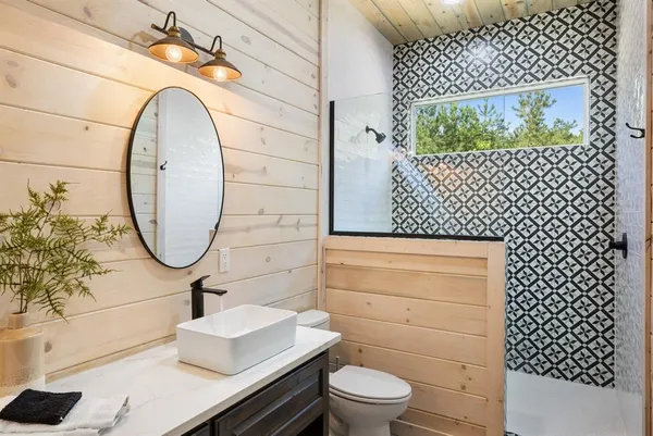 a bathroom with a toilet sink and mirror