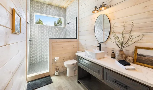 a bathroom with a double vanity sink mirror and toilet