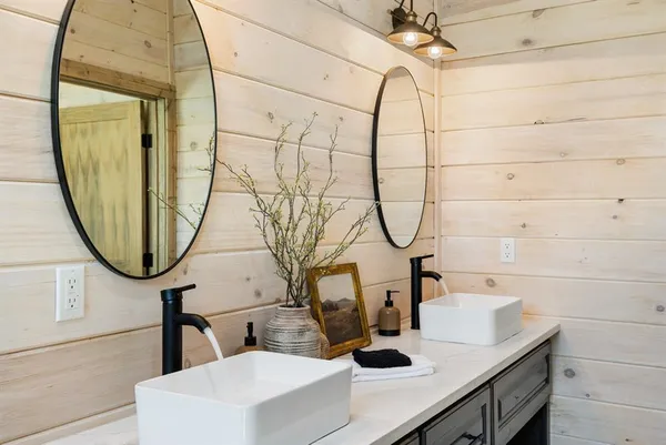 a bathroom with a sink a mirror and a shower