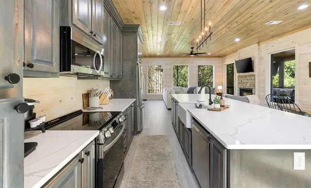 a kitchen with a sink stove and cabinets