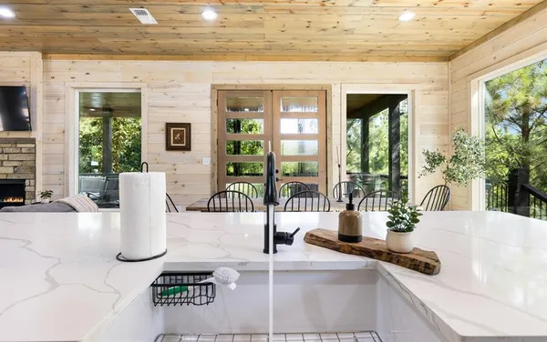 a view of a living room and kitchen