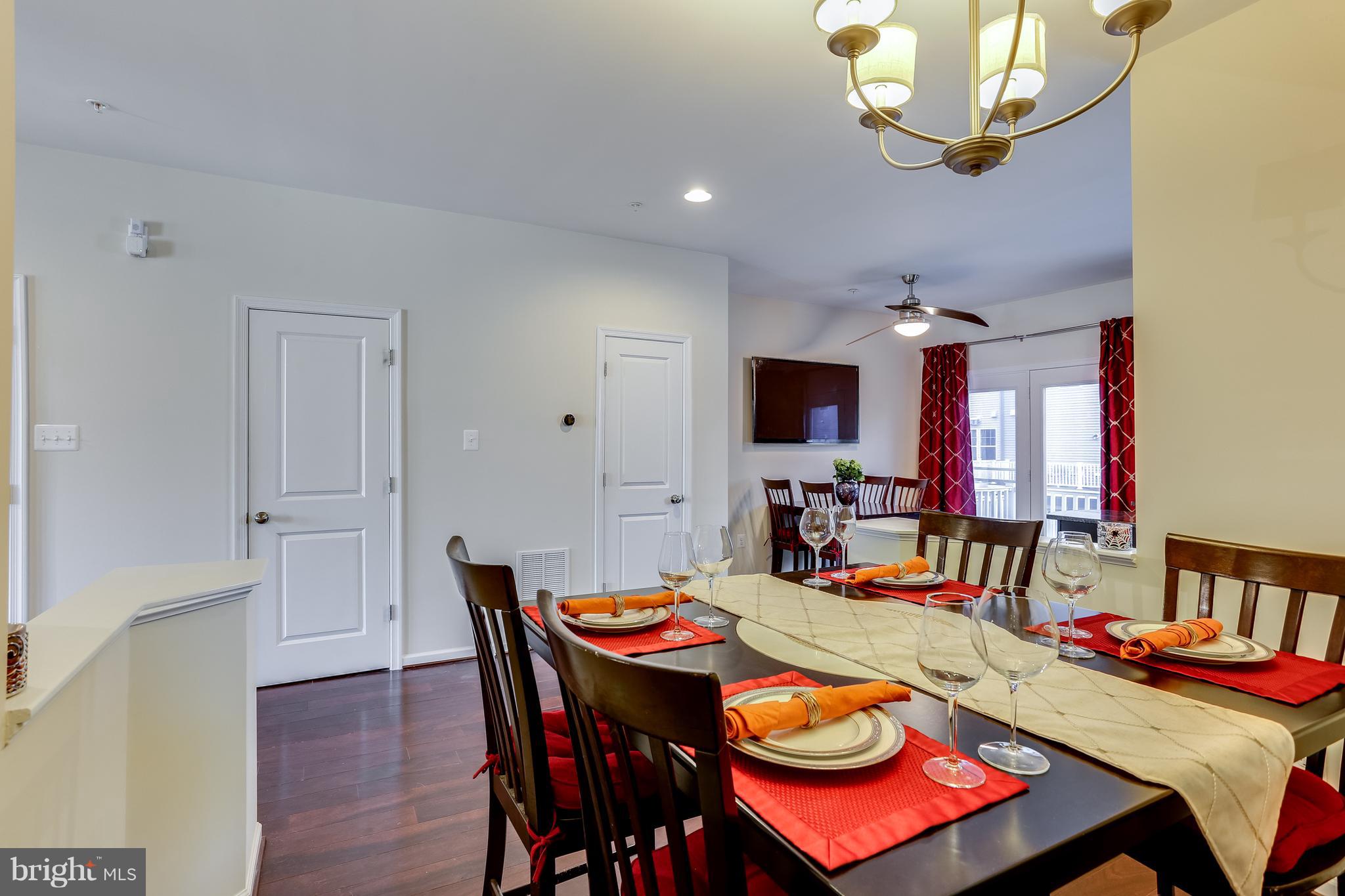 1109 Red Hawk Way Severn, MD 21144 - Photo 12 of 29 a view of a dining room with furniture a chandelier and wooden floor
