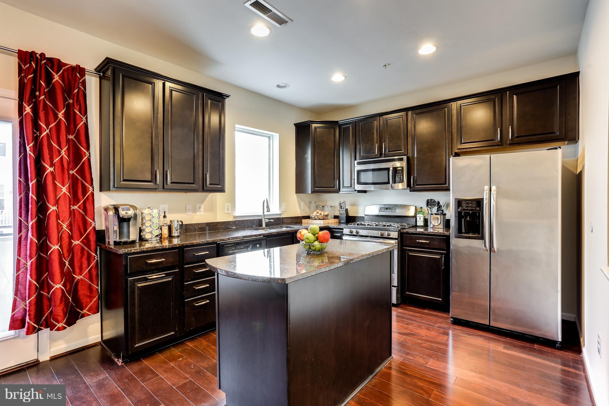 1109 Red Hawk Way Severn, MD 21144 - Photo 14 of 29 a kitchen with granite countertop stainless steel appliances and wooden cabinets