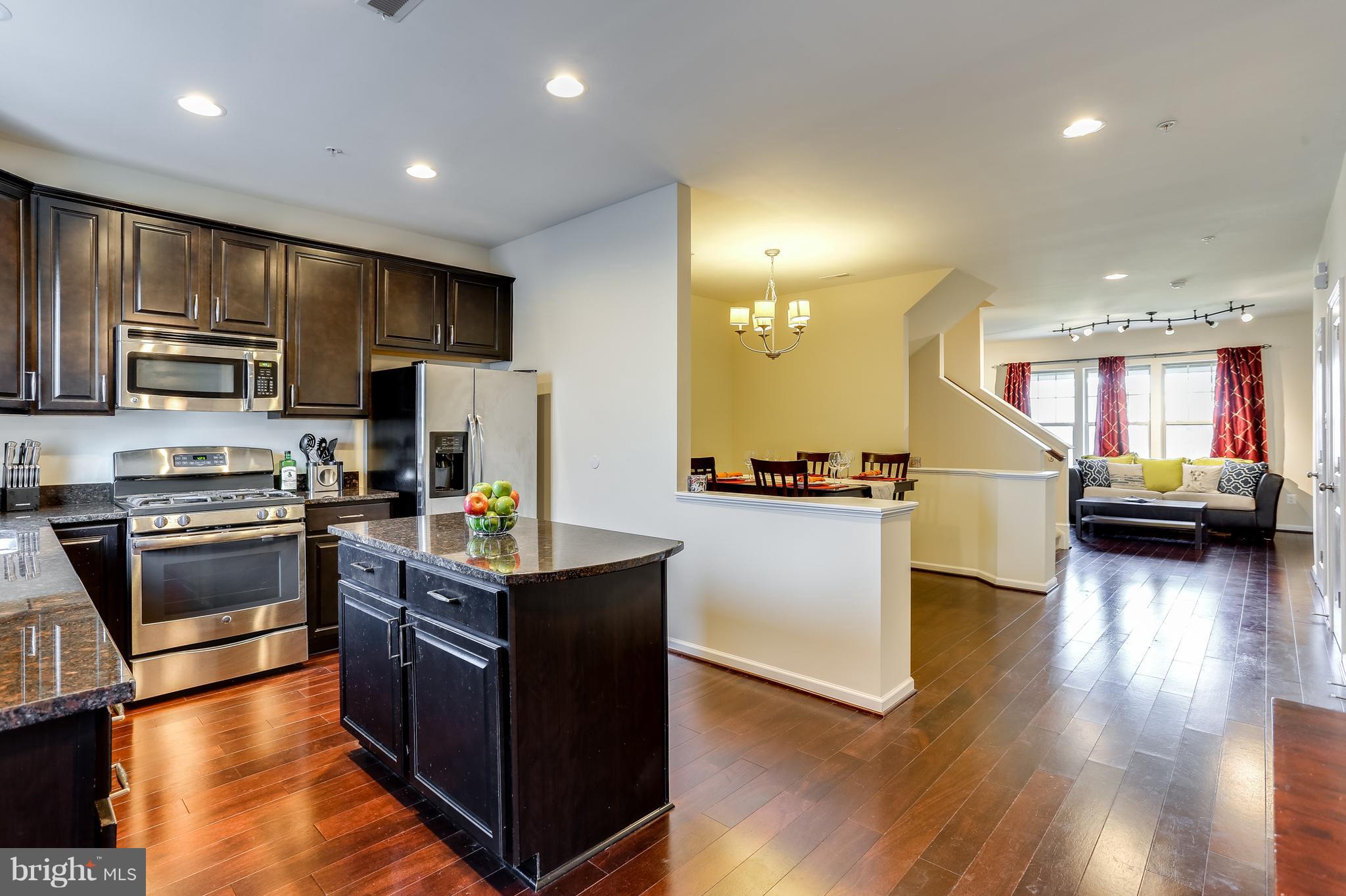 1109 Red Hawk Way Severn, MD 21144 - Photo 15 of 29 a kitchen with stainless steel appliances granite countertop a refrigerator a stove a sink dishwasher and a refrigerator with wooden floor