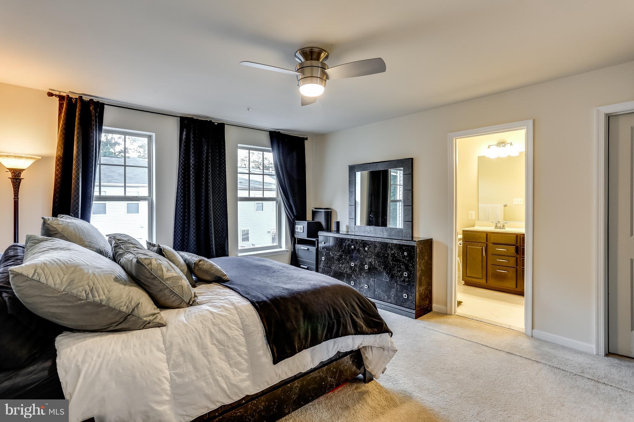 1109 Red Hawk Way Severn, MD 21144 - Photo 19 of 29 a spacious bedroom with a bed and glass windows