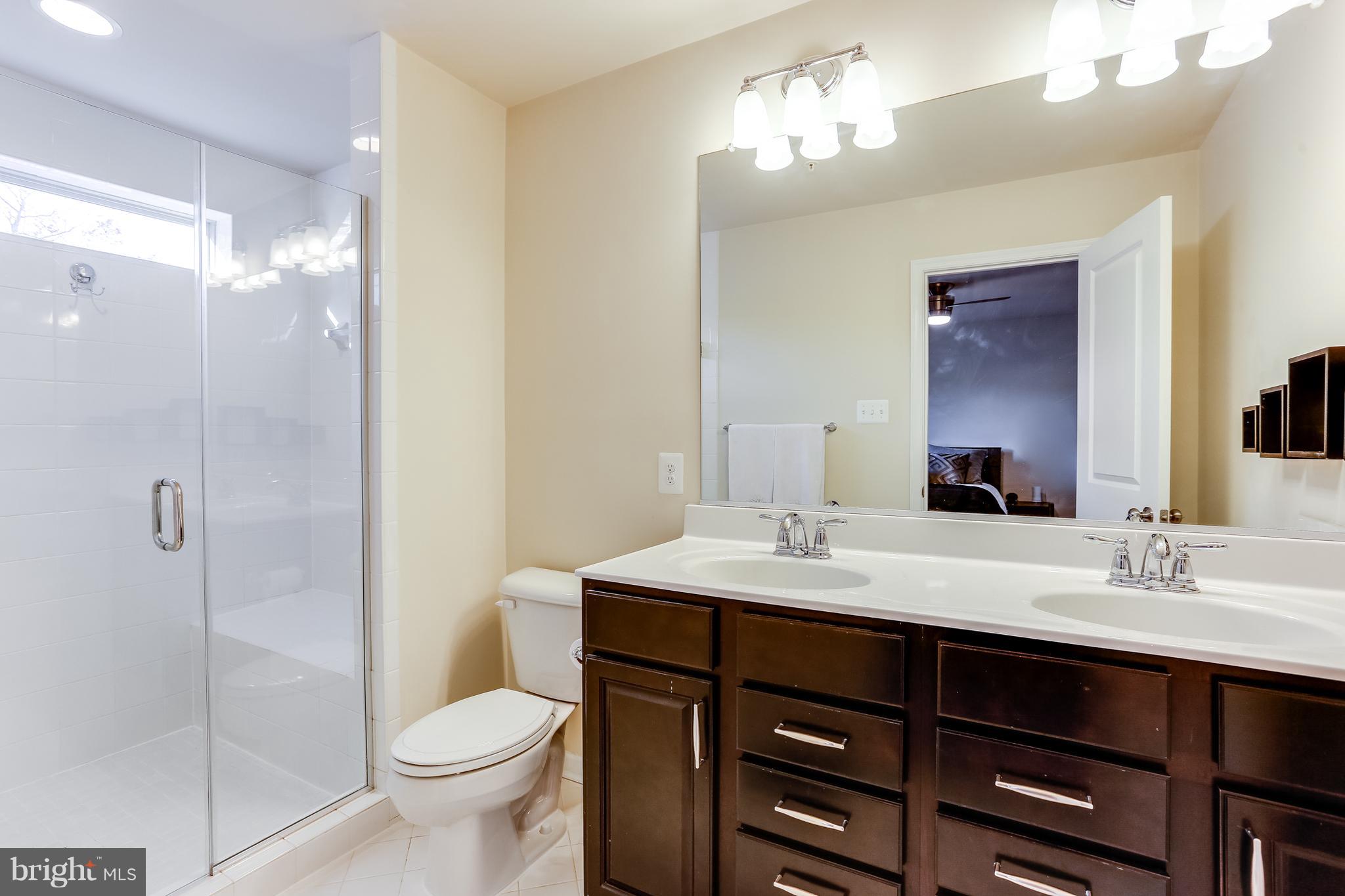 1109 Red Hawk Way Severn, MD 21144 - Photo 20 of 29 a bathroom with a sink vanity toilet and shower