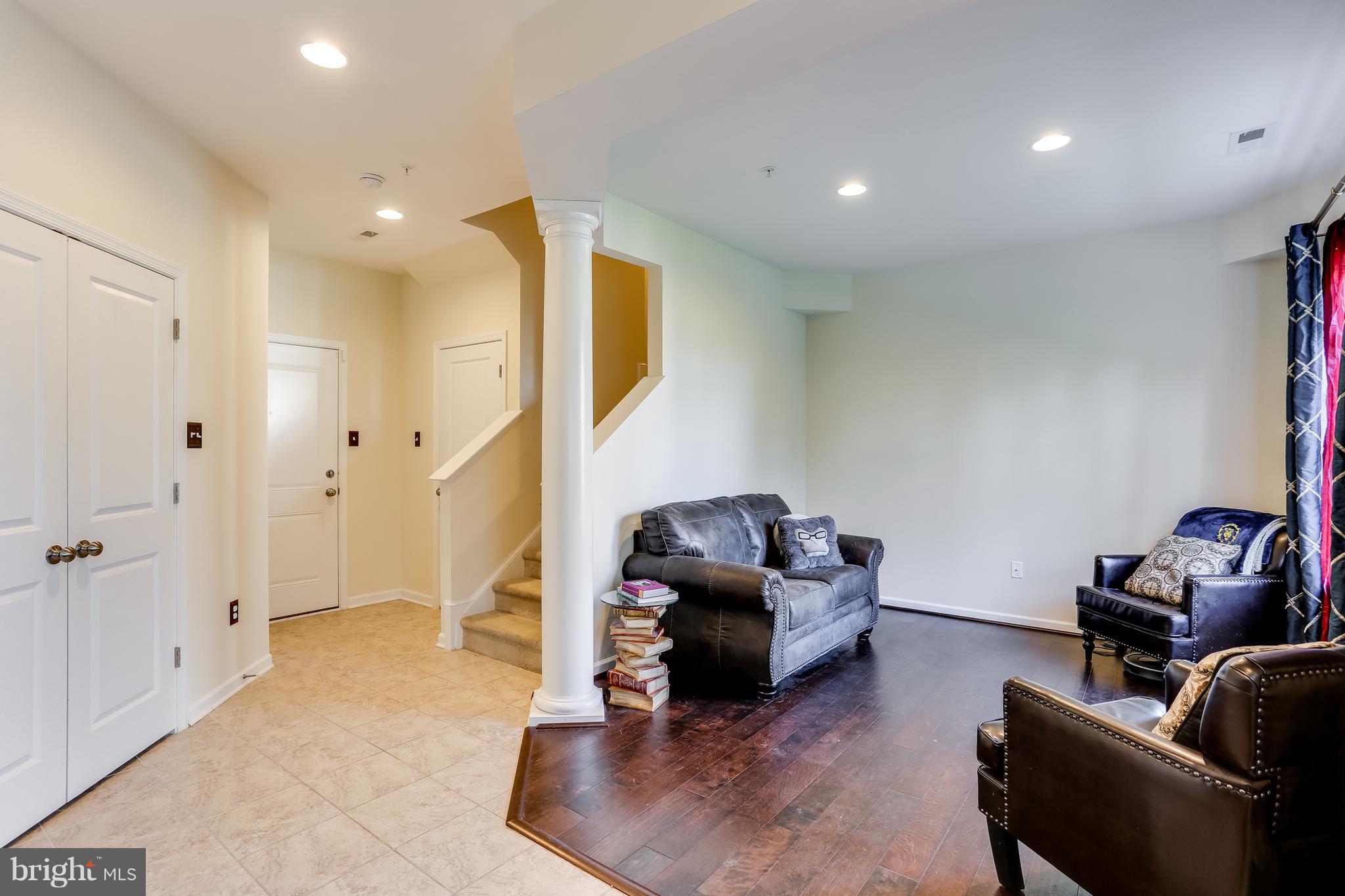 1109 Red Hawk Way Severn, MD 21144 - Photo 3 of 29 a living room with furniture and a gym machine