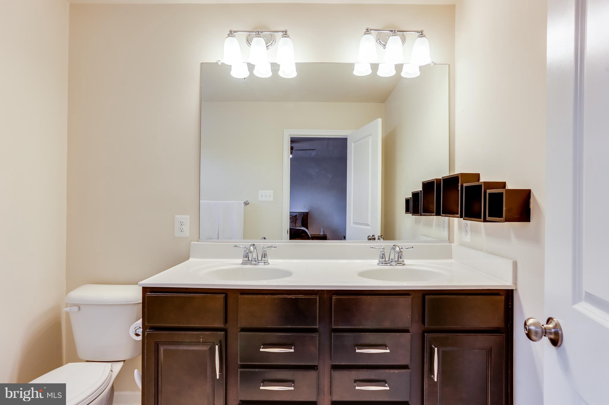 1109 Red Hawk Way Severn, MD 21144 - Photo 21 of 29 a bathroom with a sink and a mirror
