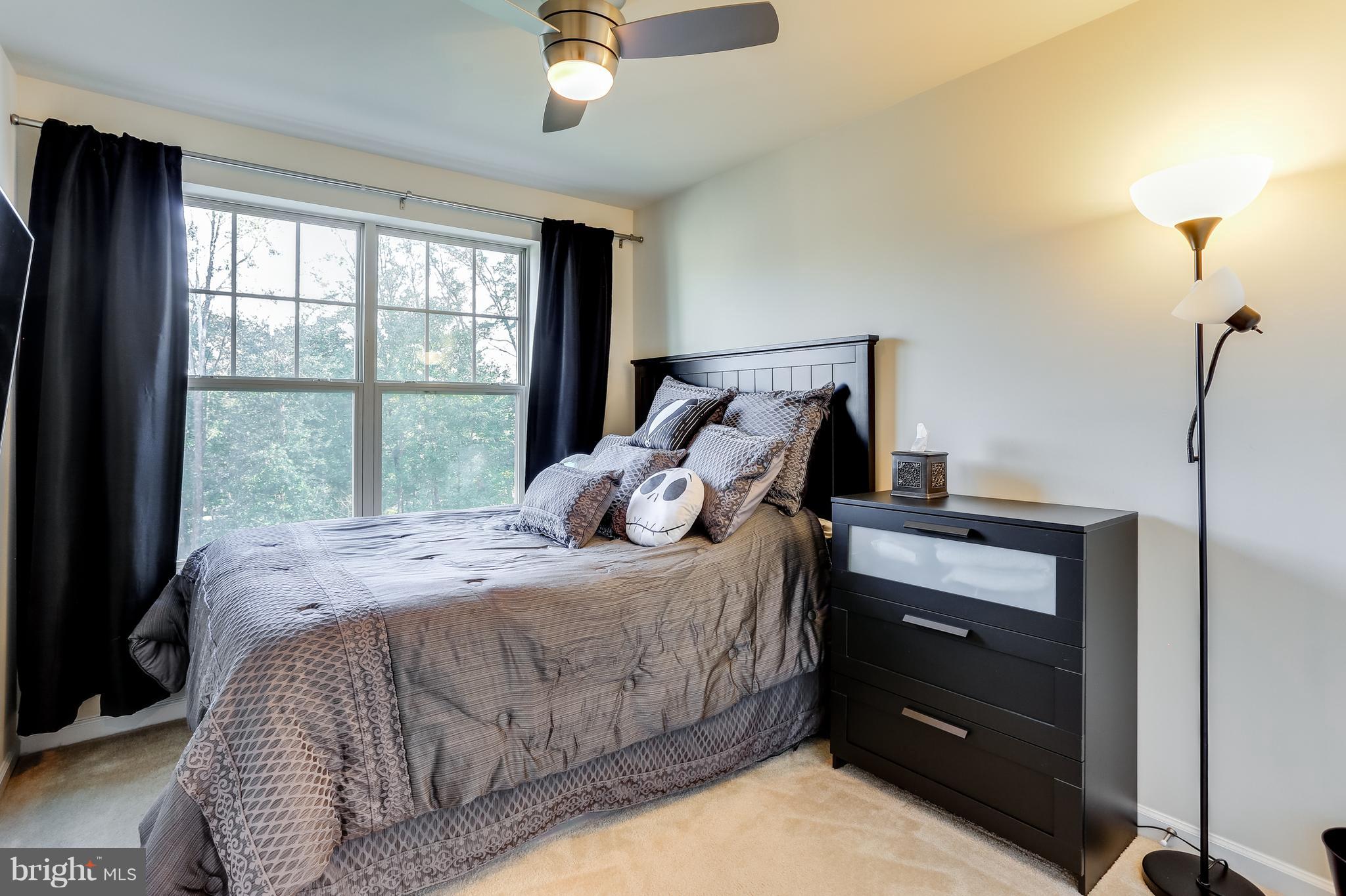 1109 Red Hawk Way Severn, MD 21144 - Photo 22 of 29 a bed sitting in a bedroom next to a window