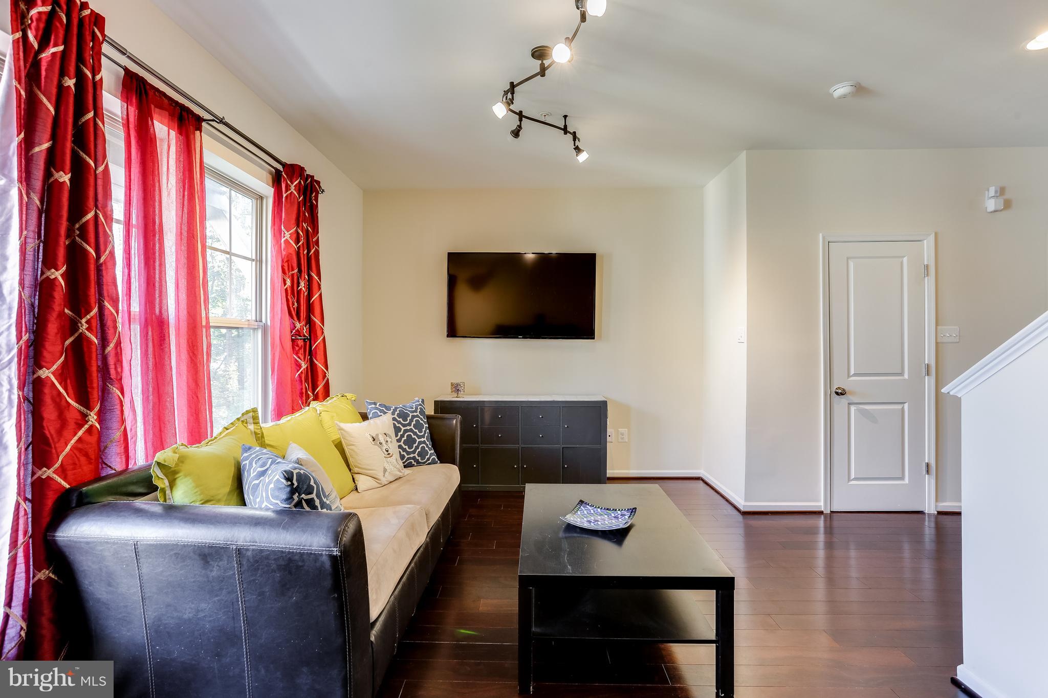 1109 Red Hawk Way Severn, MD 21144 - Photo 5 of 29 a living room with furniture and a flat screen tv