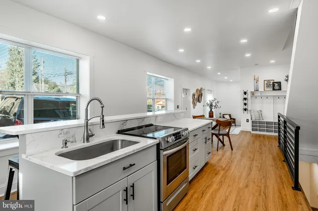a kitchen with stainless steel appliances granite countertop a stove and a sink