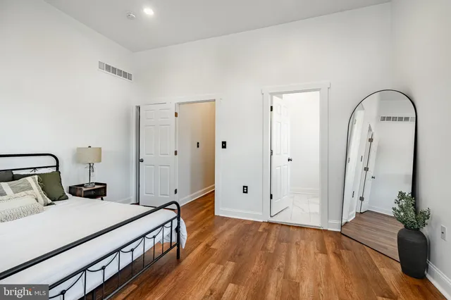 a bedroom with a bed and a potted plant