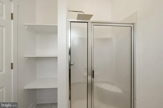 a bathroom with a glass shower door