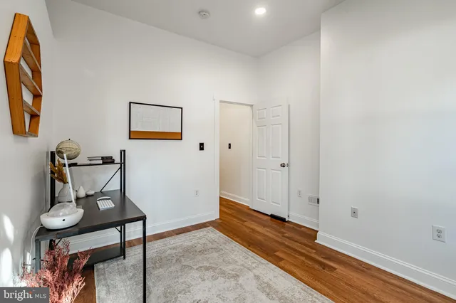 a view of room with furniture and wooden floor