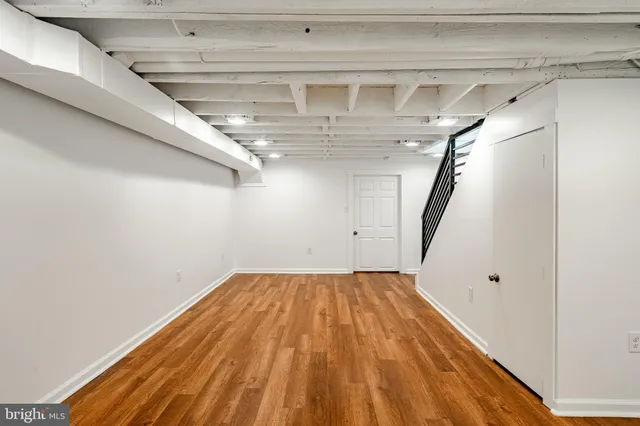 a view of a room with wooden floor