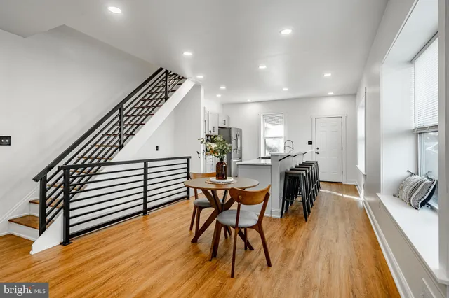 a dining room with furniture and wooden floor