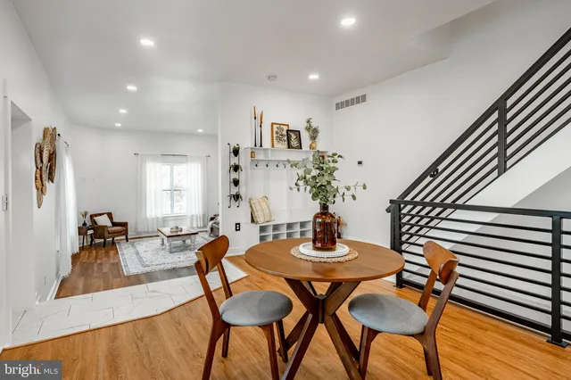 a view of a dining room with furniture and wooden floor