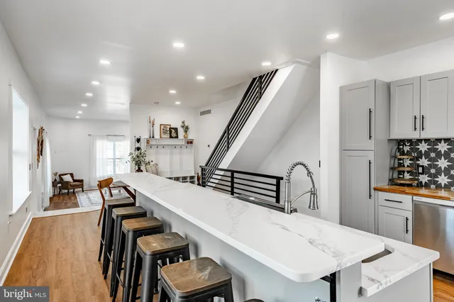 a view of a kitchen with furniture and staircase