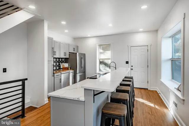 a kitchen with cabinets and chairs