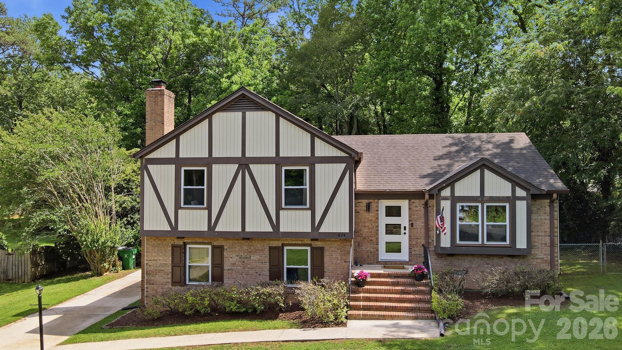 824 Riverwood Road Charlotte, NC 28270 - Photo 2 of 37 a front view of a house with garden