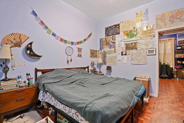 a bedroom with a bed and dresser with it