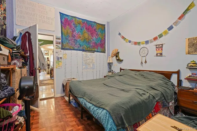 a bedroom with bed and wall painting