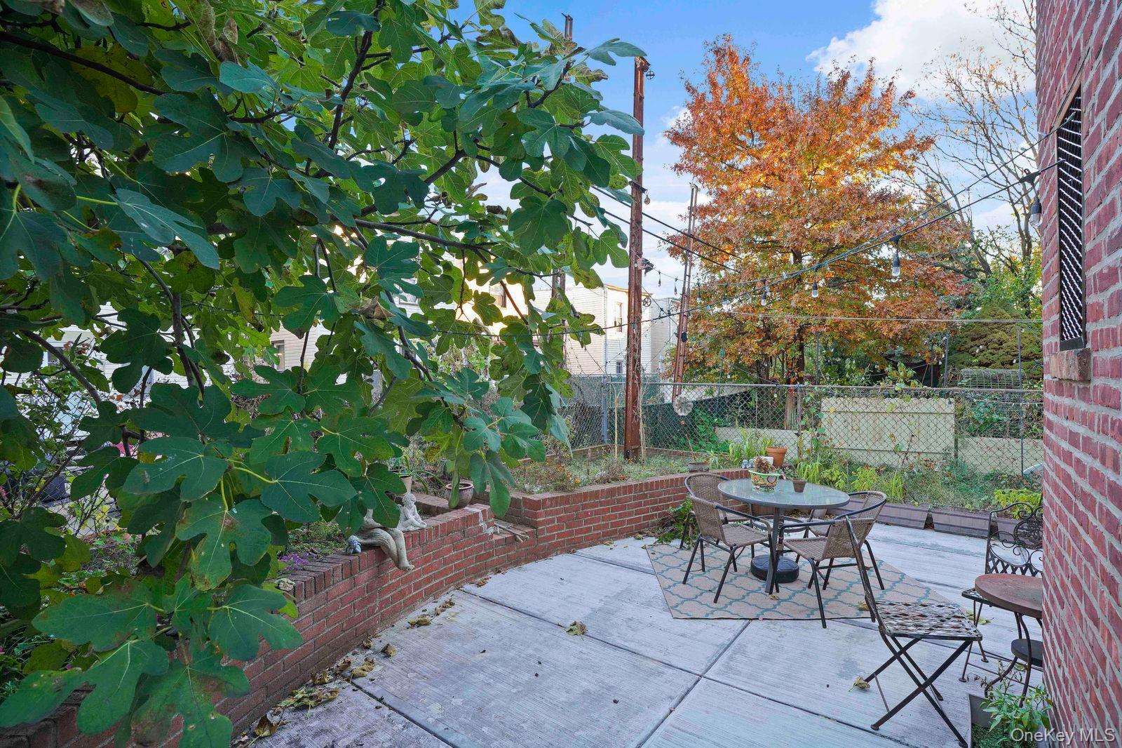 1920 Palmetto Street Queens, NY 11385 - Photo 21 of 26 a view of a tables and chairs in a backyard