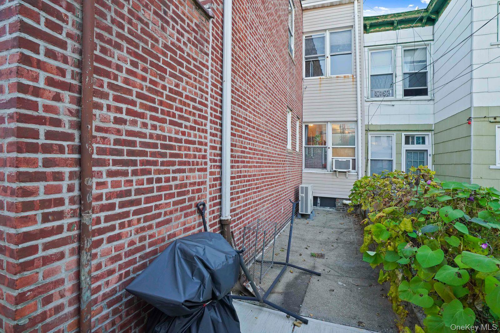 1920 Palmetto Street Queens, NY 11385 - Photo 24 of 26 a view of a backyard with plants and a chair