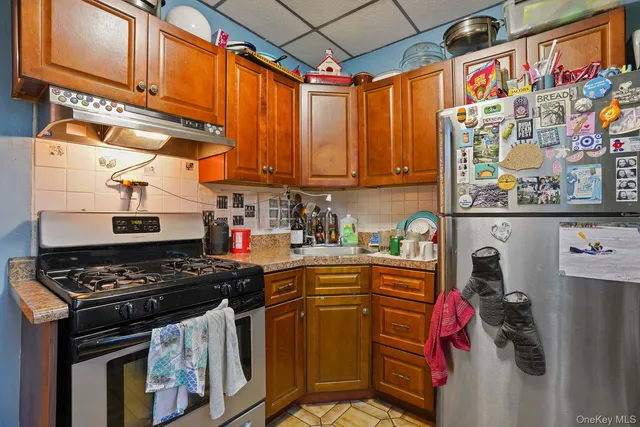 a kitchen with stainless steel appliances granite countertop a stove and cabinets