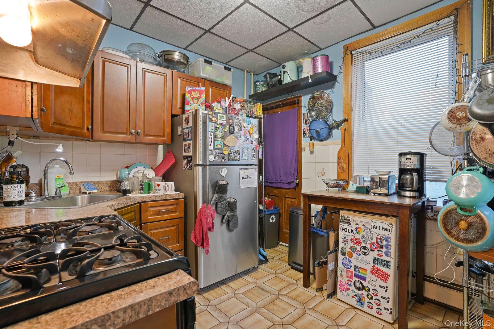 1920 Palmetto Street Queens, NY 11385 - Photo 6 of 26 a kitchen with lots of appliances and cabinets