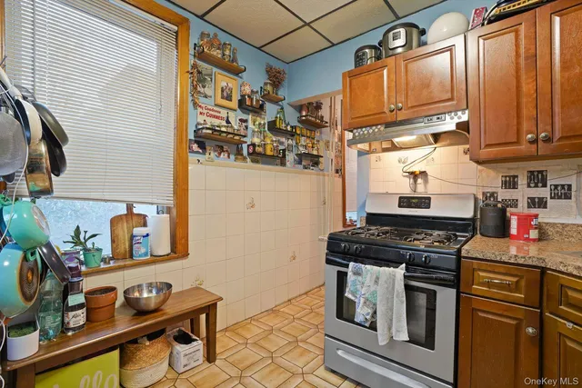 a kitchen with stainless steel appliances granite countertop a stove and a refrigerator