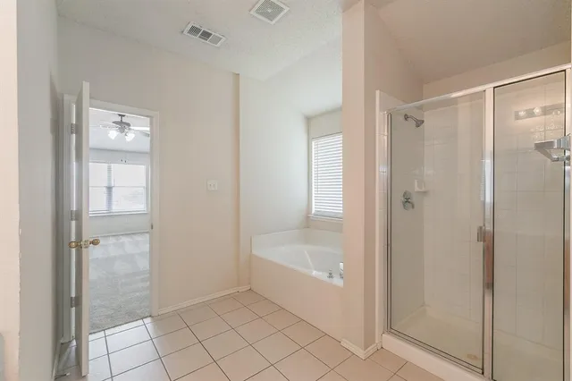 a bathroom with a bathtub and shower