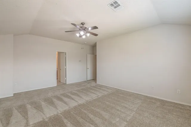 a view of an empty room with a fan