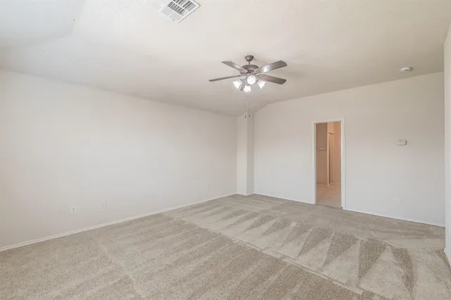 a view of an empty room with a fan