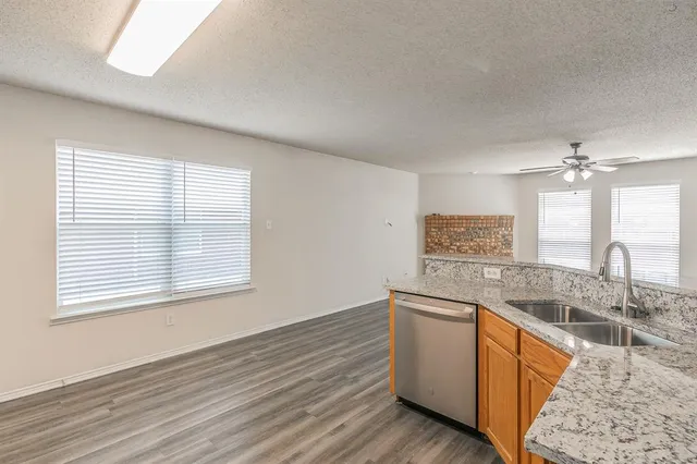 a view of a kitchen counter space stove and wooden floor