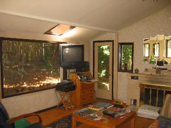 901 Smith Road Mill Valley, CA 94941 - Photo 4 of 8 a living room with furniture a flat screen tv and a floor to ceiling window