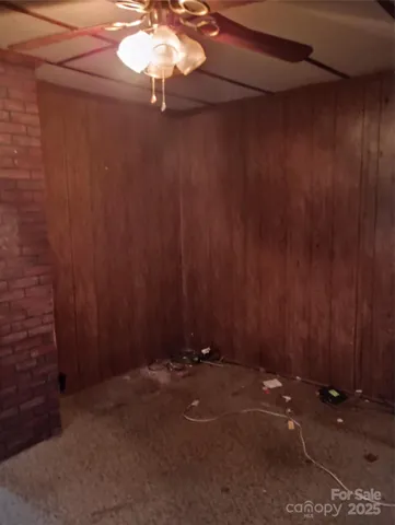 a view of a closet with a fan and wooden floor