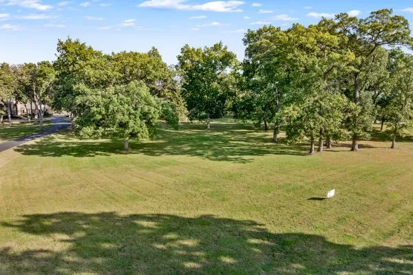 a view of outdoor space with trees all around