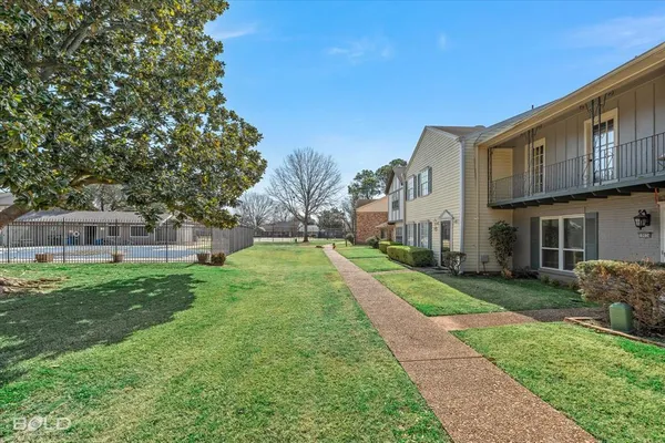 a view of a yard in front of a house