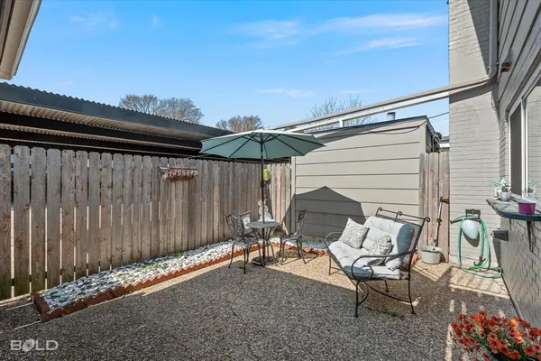 a view of a patio with a table and chairs