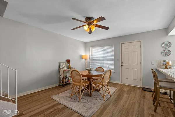 a kitchen with kitchen island a stove a refrigerator cabinets and a dining table